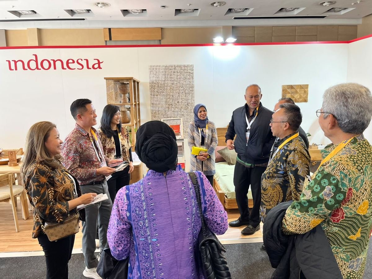 Delegates talking at the Indonesia Pavilion with a coconut shell mosaic wall panel behind them, Decorex Johannesburg 2026
