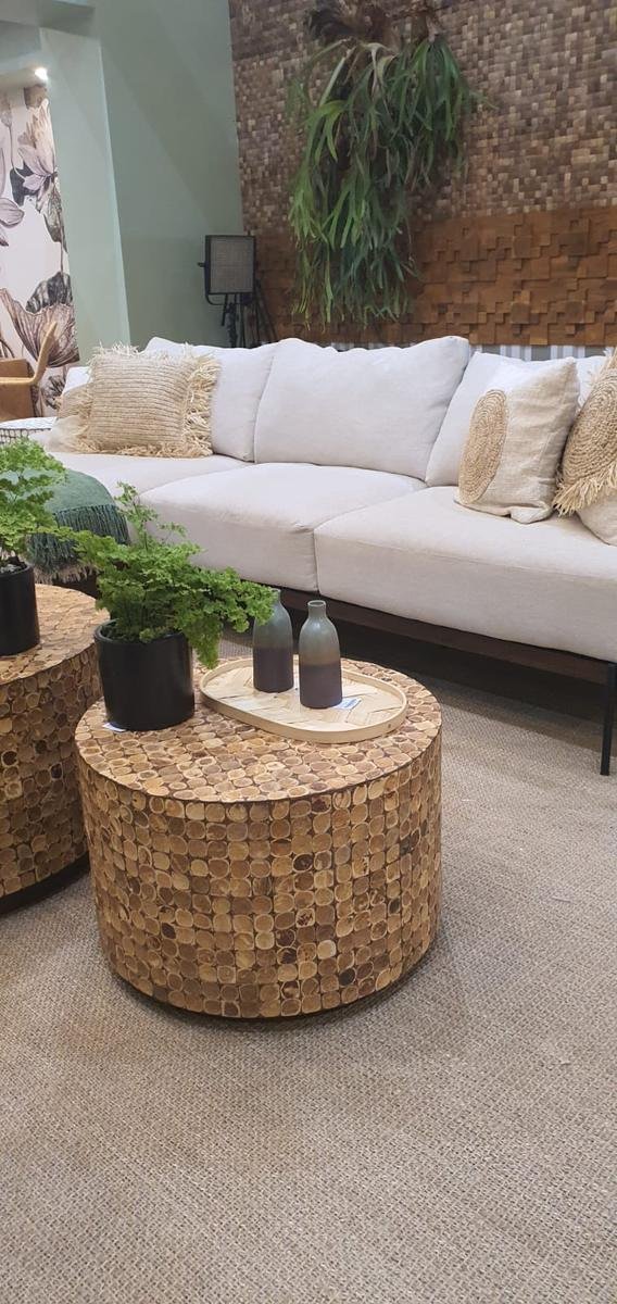 Cocora coconut shell mosaic coffee table in front of a sofa and a coconut shell and teak feature wall, KKI 2026