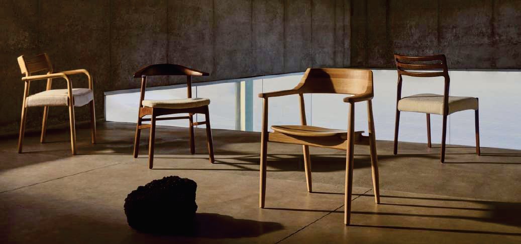 Teak dining chairs with woven seats in a sunlit dining room